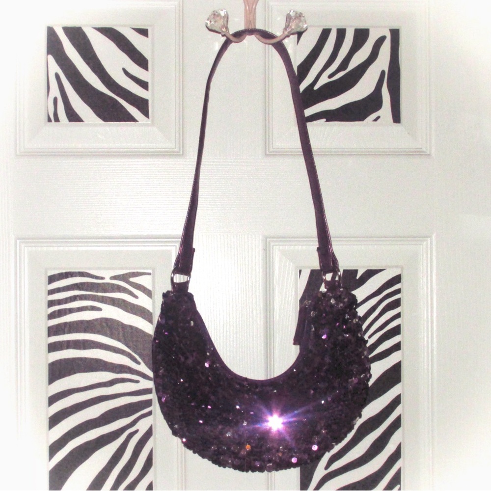 Purple and gold sequin shoulder bag with a zipper closure.